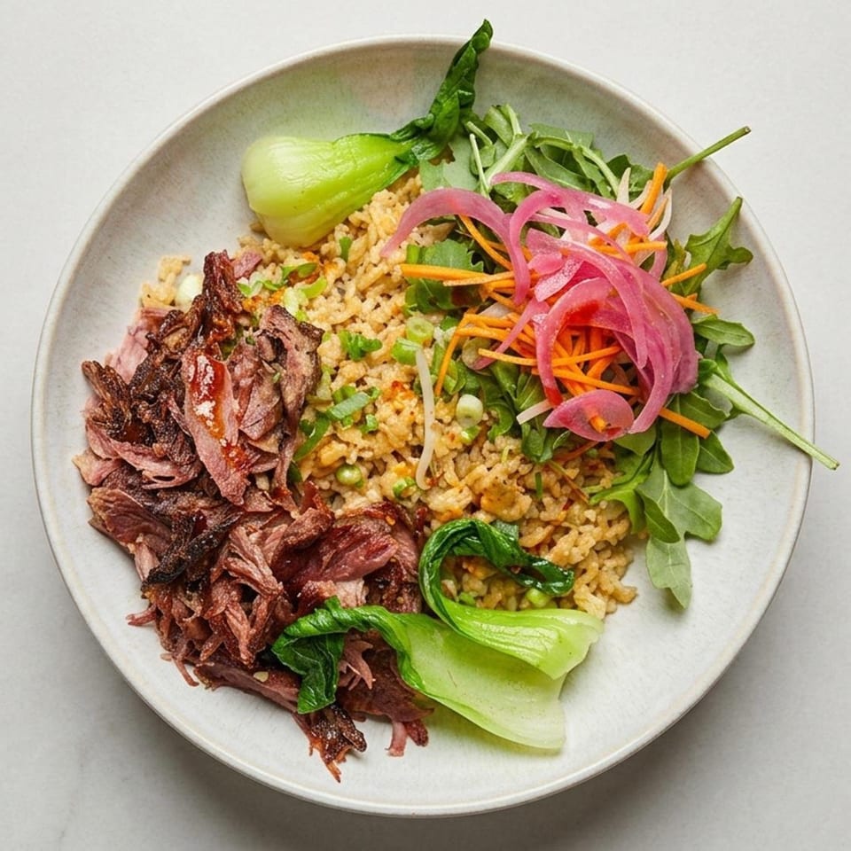 Bowl of seasoned rice topped with sliced grilled meat, leafy greens, pickled onions, carrots, and bok choy.